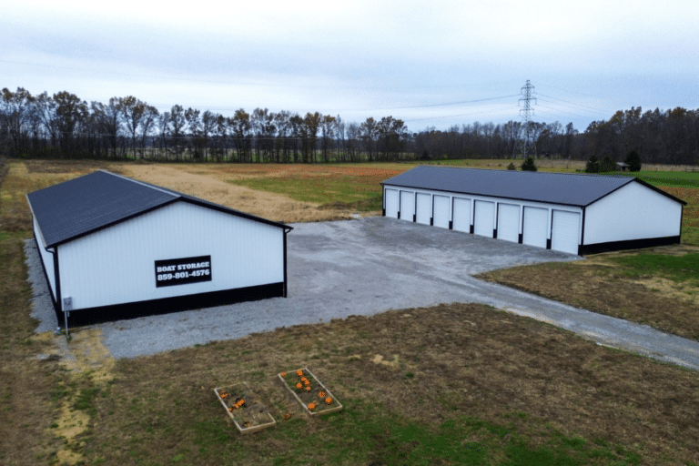 two white and black pole barn garages