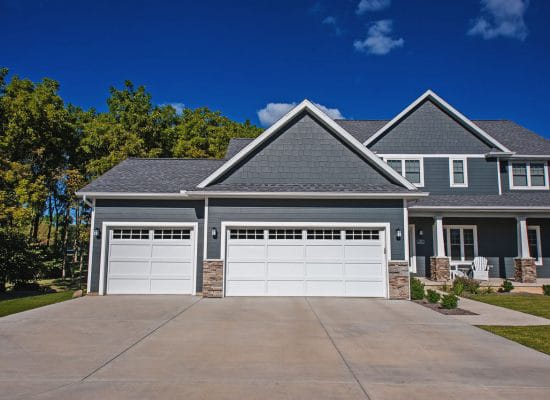 two white garage doors with transom windows