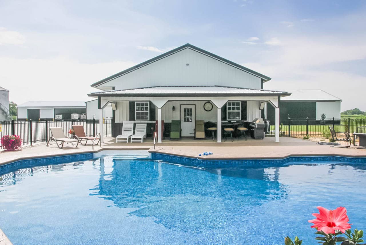 25x25 white barndominium with porch by pool