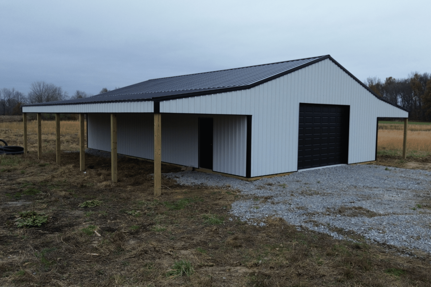 white 60x70 garage pole barn kit with black garage