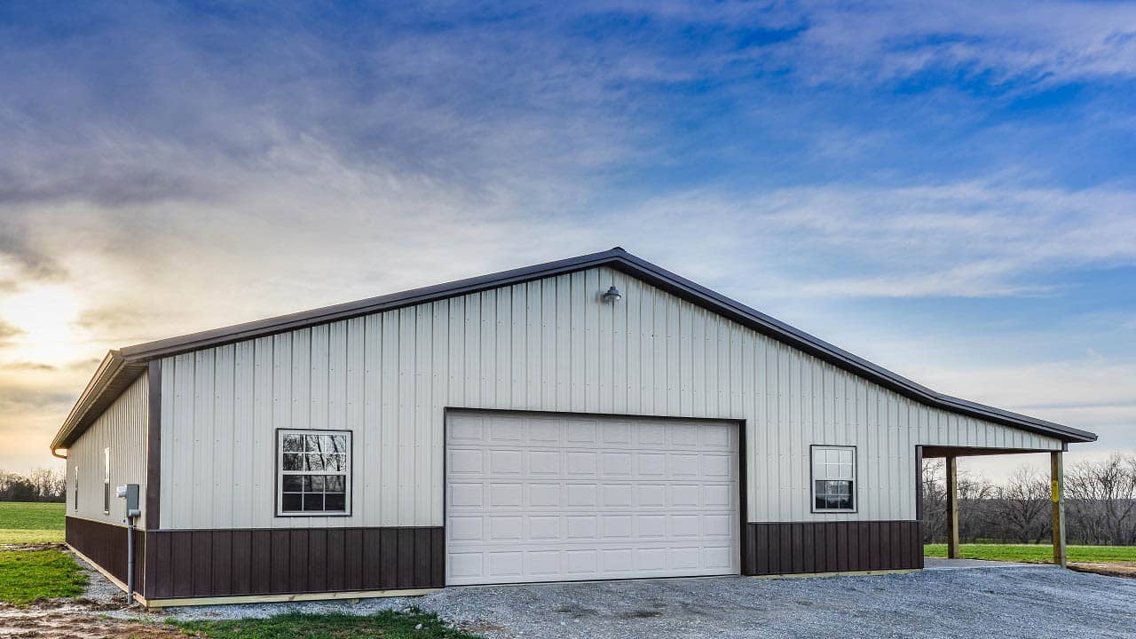white 70x80 pole barn garage with dark trim, and a side porch