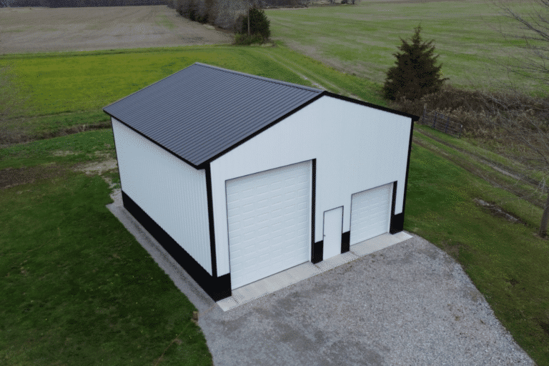 white and black 30x32 garage pole barn kit in sardinia ohio with one big garage and a small garage
