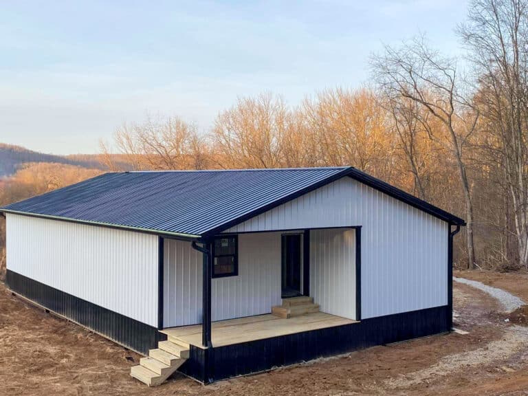 white and black trimmed 32x56 barndominium with side and front porches