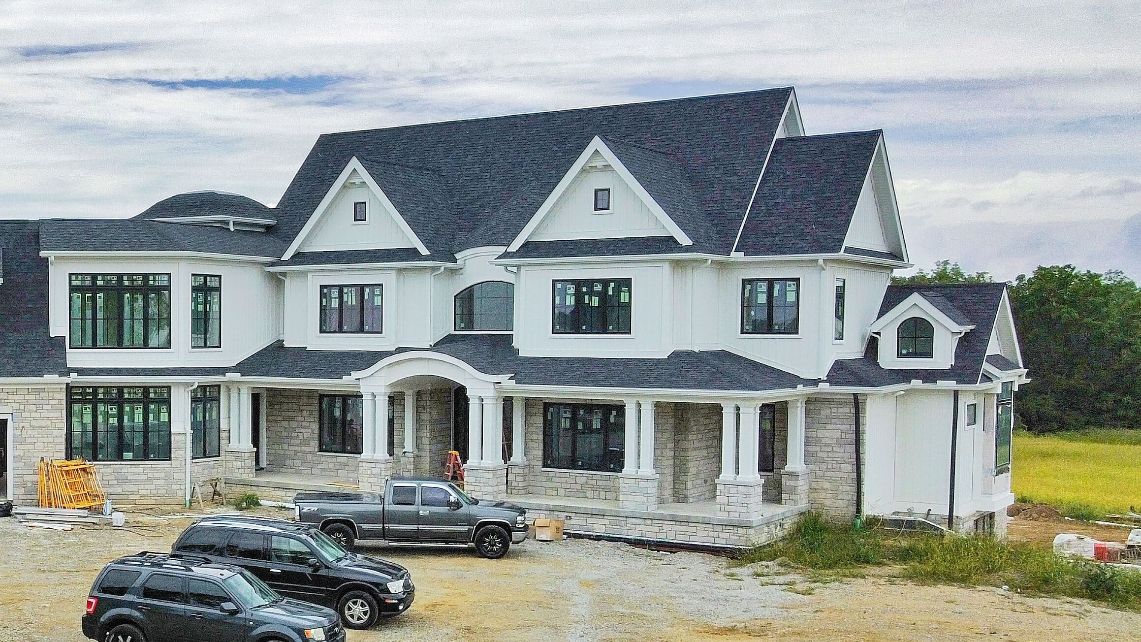 white and stone trimmed barndominium
