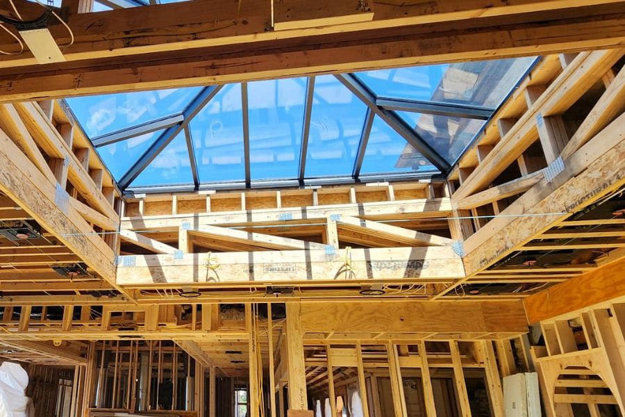wooden roof trusses custom cut to fit in skylight in luxury home