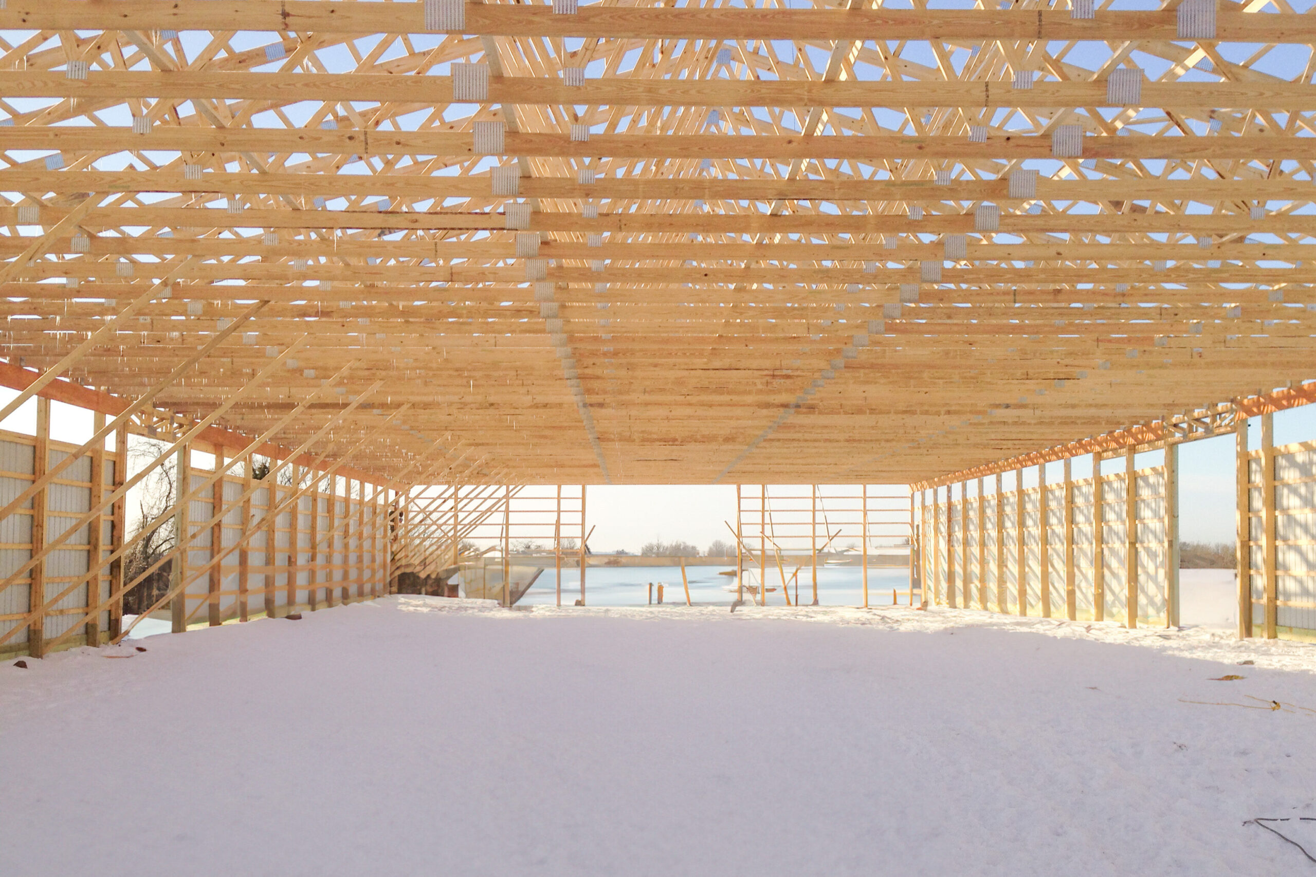 wooden roof trusses visible from the inside of a 24x40 pole barn garage