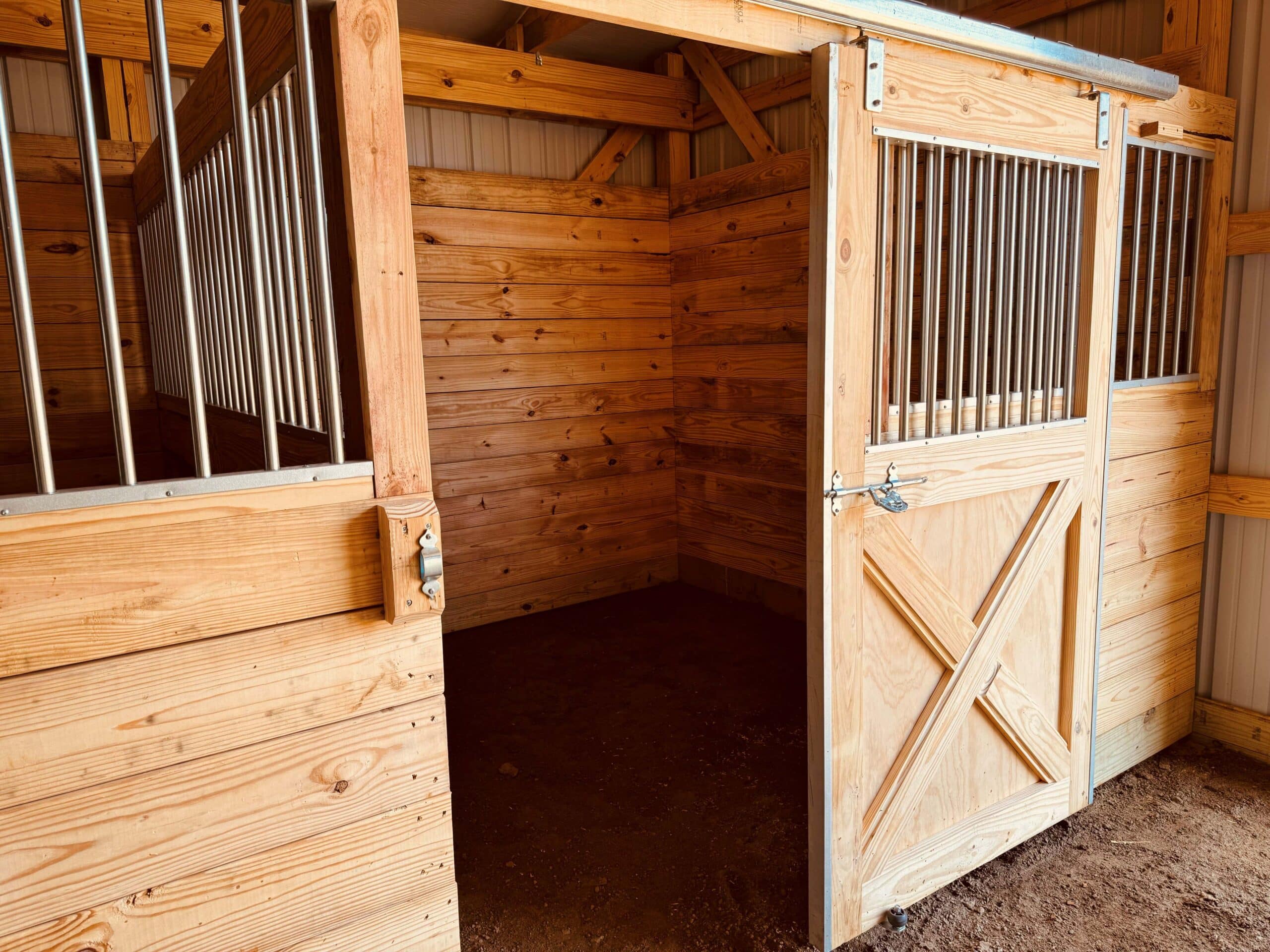 wooden stall inside agricultural pole barn